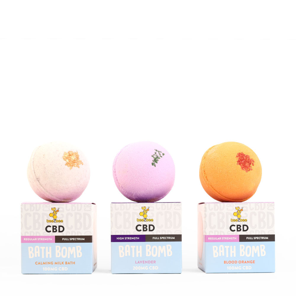 A trio of beeZbee full spectrum CBD bath bombs in the scents Blood Orange, Lavender, and Calming Milk Bath.